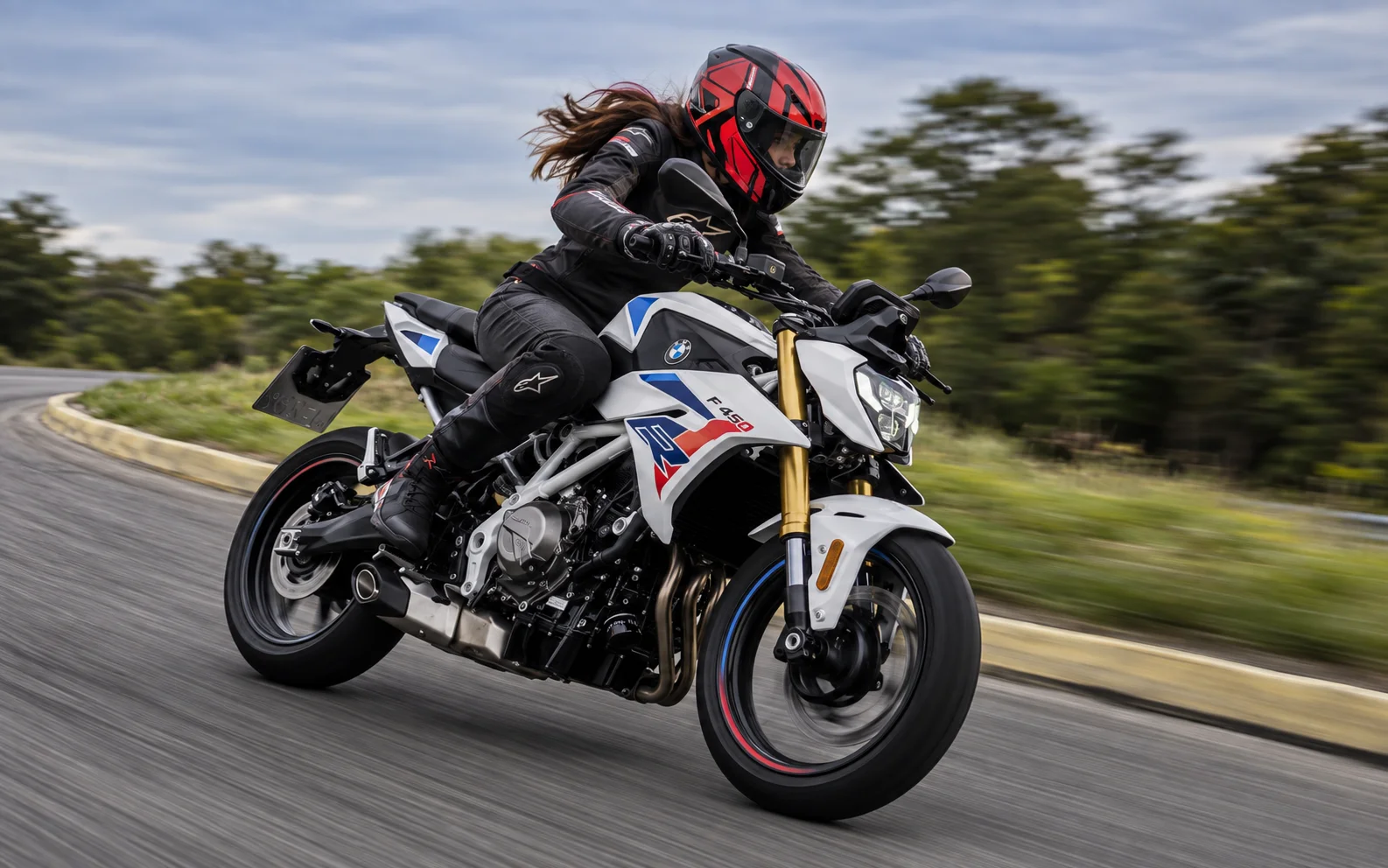 Mulher pilotando a BMW F 450 R com equipamentos completos